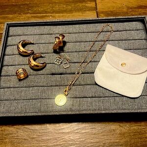 Three sets of earrings, a necklace, a ring and a jewelry bag.